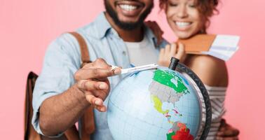 Go on an adventure. Happy couple preparing for journey, choosing route on pink background photo