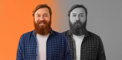 A man stands confidently, showcasing his full beard. He is dressed casually in a checkered shirt and white t-shirt, set against a vibrant orange and monochrome background that enhances his emotions photo