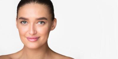 A close-up view of a woman face in the center of the frame, set against a plain white background. The woman features are visible without distractions, showcasing her expression, blank space photo