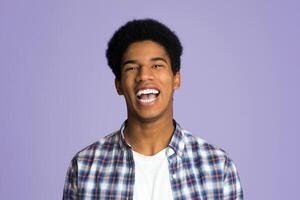 Excited guy laughing and looking at camera over pink background photo