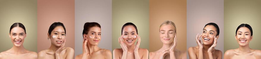 Seven women with varying skin tones stand in a studio setting, each applying facial skincare products to their faces. They are all smiling and appear happy with the products. photo