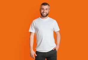 A man is standing in a casual posture with his hands tucked into his pockets. He appears relaxed and contemplative as he gazes ahead. His body language exudes a sense of confidence and ease. photo