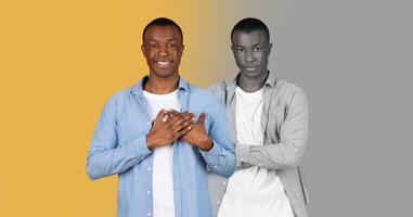 Black man confidently poses. The background features a striking two-tone design, with one side in vibrant yellow and the other in muted gray, highlighting his expression. photo