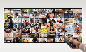 A hand holding a remote control is pointing at a large television screen. The screen is displaying a grid of small videos, each depicting a different activity photo