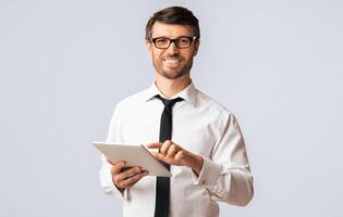 Positive Businessman Using Digital Tablet Standing Over White Background In Studio. Empty Space, Isolated photo