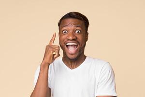Idea. Excited African American Man Pointing Finger Up Coming Up With Problem Solution Standing On Yellow Studio Background. photo