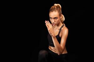 Spot Jogging. Motivated Lady Running In Place Exercising Over Black Studio Background. Emtpy Space For Text photo