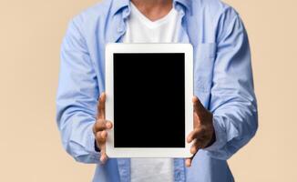 Great Application. Smiling Black Guy Showing Blank Tablet Computer Screen Posing On Yellow Studio Background. Mockup, Cropped photo