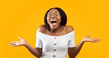 Wow. Excited Afro Girl Shouting Looking At Camera Gesturing With Hands Standing On Orange Studio Background. Panorama photo