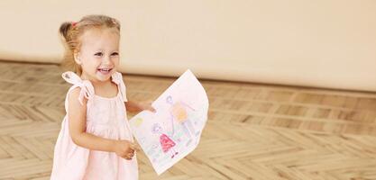 Happy little child running to father and holding a drawing with Daddy and Me text photo