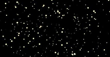 Gold bokeh on particles floating in the air. Dust and glitter particles background. Black background , Use blending mode screen video