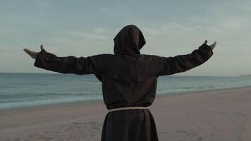 Religious Monk With Prays Towards The Sea With Open Arms video