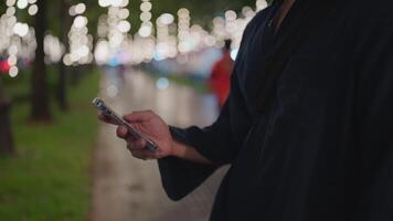 Man hands using smartphone device at interactive exhibition with colorful illumination scroll, video