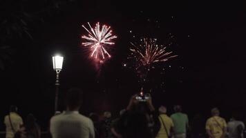 People observe sky sky with explosion of fireworks video