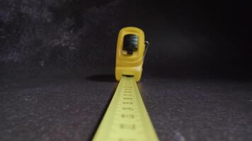 Motion above retractable ruler with plastic casing on table video