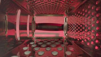 Inside of grater with sharp teeth under red illumination video
