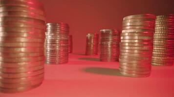 Motion between stacks of coins on table at gentle red light video