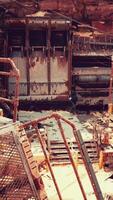 A dilapidated building covered in rust and debris video