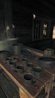 A rustic wooden table filled with an assortment of colorful cups video