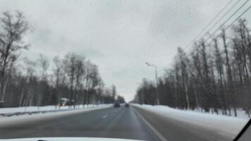 Driving a car on the highway in winter, view from the car window. High quality 4k footage video
