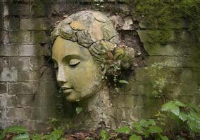 A serene angel's face is etched on a weathered wall photo