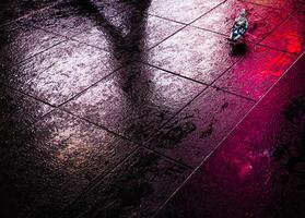 A person sitting on a floor with a red light photo