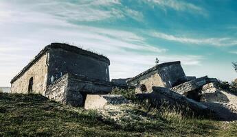 Old fortifications in the middle of a grassy field photo