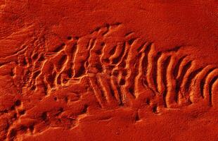 Dunes on the sea shore. Ripples in wet sand background texture. Beach sand background photo