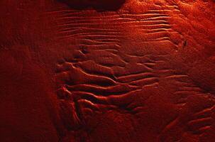 Dunes on the sea shore. Ripples in wet sand background texture. Beach sand background photo
