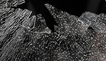 A broken glass window with a black background photo