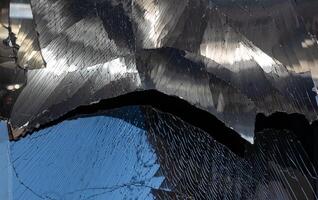 A broken mirror with a reflection of a building photo