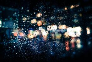 Rainy night with blurred lights on the street photo