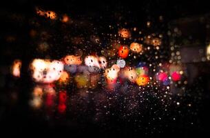 Rainy night with blurred lights on the street photo
