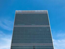 A tall building with a blue sky in the background photo