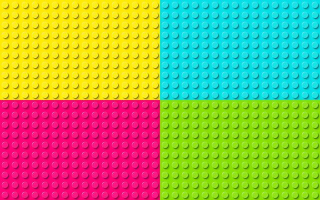 Plastic construction plate. Yellow, blue, pink and green plastic toy block background. Abstract seamless pattern