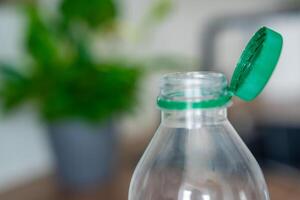 Stationary plastic cap on a PET bottle. The new design means the cap remains attached to the bottle after opening, making the entire package easier to collect and recycle. High quality photo