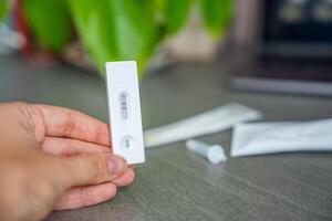 Rapid Antigen Test kit with with Positive result during swab COVID-19 testing. Coronavirus Self nasal or Home test, Autumn exacerbation of viruses. High quality photo