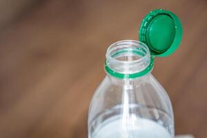 Stationary plastic cap on a PET bottle. The new design means the cap remains attached to the bottle after opening, making the entire package easier to collect and recycle. High quality photo