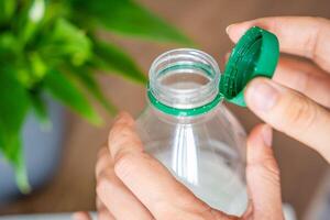 Stationary plastic cap on a PET bottle. The new design means the cap remains attached to the bottle after opening, making the entire package easier to collect and recycle. High quality photo