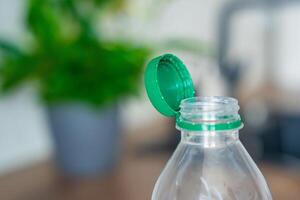 Stationary plastic cap on a PET bottle. The new design means the cap remains attached to the bottle after opening, making the entire package easier to collect and recycle. High quality photo