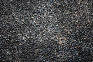 dirty and rough black stone pavement texture and background photo