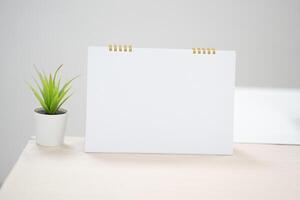 Blank desk calendar on table in mock up and copy space concept. photo