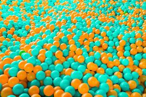 Ball pool playground teal and orange background with copy space for text. photo