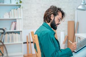 Man working with computer digital tablet stylus pen at modern office. photo