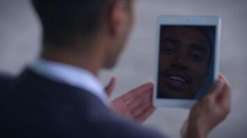 A person on a call using a tablet, showing interest and attentiveness in communication video