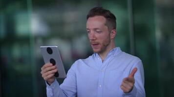 A person on a call using a tablet, showing interest and attentiveness in communication video