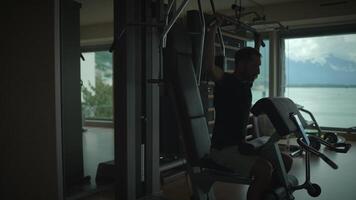 Engaging in a Focused Workout within a Modern Home Gym that Offers Scenic and Serene Views video