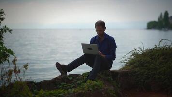 Enjoying Remote Work by the Water Embracing Laptops in Natures Embrace and Beauty video