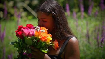 A beautiful woman surrounded by colorful flowers in a lush and vibrant garden setting video