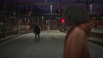Lonely and isolated figures standing at dusk on a longabandoned, rusty train track video